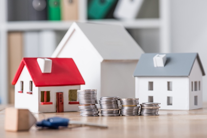 Miniature homes and coins representing property planning
